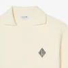 Polo de malha com efeito de cetim e corte largo com emblema